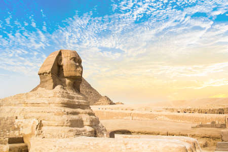 Great Sphinx against the background of the pyramids of the pharaohs Cheops, Khafren, and Mikerin in Giza, Egyptの写真素材