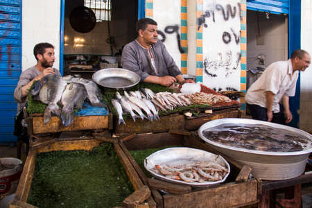 CAIRO, EGYPT - DECEMBER 29, 2021: Seller at the Central Fish Market in Cairo, Egypt