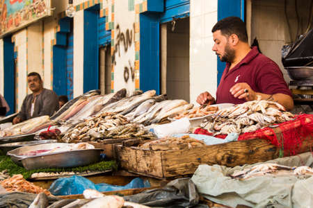 CAIRO, EGYPT - DECEMBER 29, 2021: Seller at the Central Fish Market in Cairo, Egyptのeditorial素材