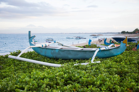 Beautiful view of the boats on Kuta beach in Bali Island, Indonesiaの写真素材