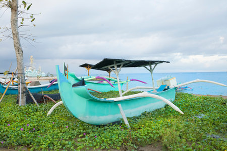 Beautiful view of the boats on Kuta beach in Bali Island, Indonesiaの写真素材