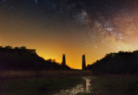 Broken bridge on a Milky Way Background. A starry sky over the creek and bridge bearingの写真素材