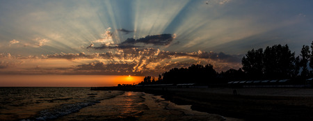 Fascinating clouds flashing by bright sunlight over the Black Sea seaside view in Lazurne, Kherson regionの写真素材