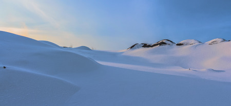 Winter landscape at the daytime in Krivoy Rog, Ukraine. Mountains covered by snow. Landscape on the blue sky background. Snow desert landscape.の写真素材