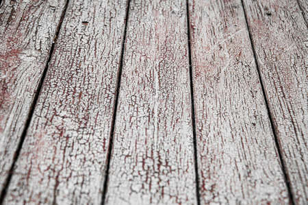 white paint on old cracked brown black boardの写真素材