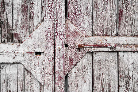 white paint on old cracked brown black boardの写真素材