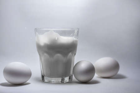 Milk in a glass jar and eggs