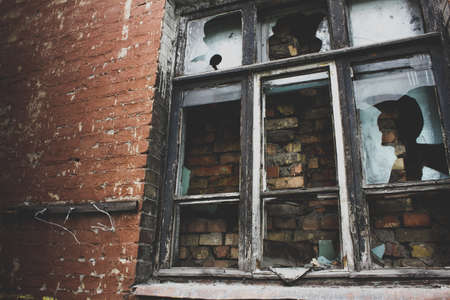 old wooden window frame with broken glassの写真素材