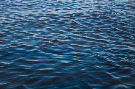 Blue sea water surface with sparks summerの写真素材