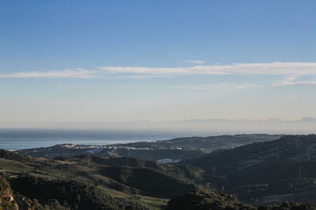 Natural mountain scenery with windmills generating electricityの写真素材