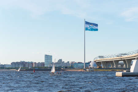 Saint Petersburg, Russia - July 14, 2020: a flag of football club Zenit waves against the blue sky on Krestovsky Island. This is the tallest flagpole (105 m) in Europe.のeditorial素材
