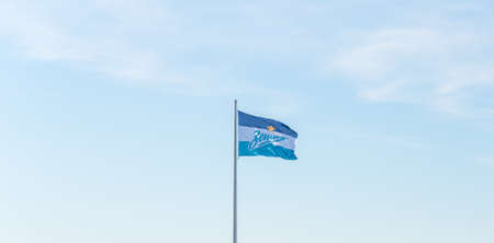 Saint Petersburg, Russia - July 14, 2020: a flag of football club Zenit waves against the blue sky.のeditorial素材