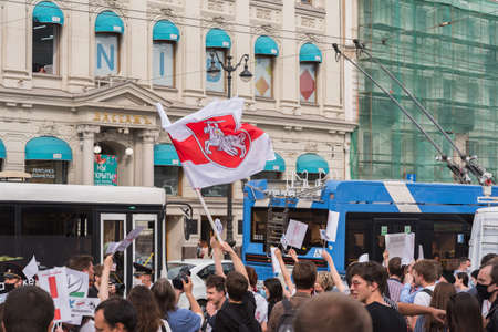 Saint Petersburg, Russia - August 22, 2020: people support democracy in Belarus waving with a white-red-white flag over Nevsky Prospect at a rally at Gostinyy Dvor Metro Station.のeditorial素材