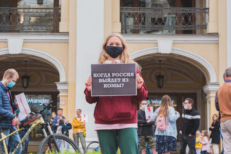 St Petersburg, Russia - August 29, 2020: a protester holds a poster "When will Russia come out of a coma?" at a rally at Gostiny Dvor. References to poisoning of Navalny & Russia's political inertia.のeditorial素材