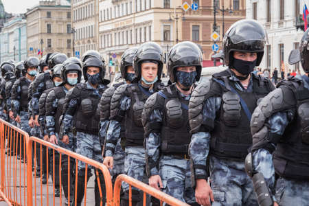 Saint Petersburg, Russia - August 22, 2020: young Russian national guardsmen in disposable masks cordon the space of a protest rally.のeditorial素材