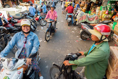 Ho Chi Minh City, Vietnam - April 15, 2019: people on motorbikes in an alley at Cho Binh Tay market in Cho Lon (Cholon).のeditorial素材