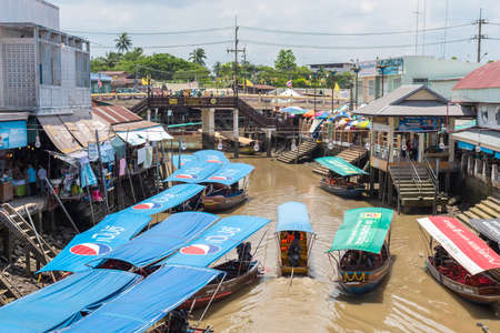 Amphawa, Thailand - June 15, 2019: a fleet of traditional Thai boats with Pepsi logos at Amphawa Floating Market. Advertising as a form of pollution, tourism as a way of destroying authenticity.のeditorial素材