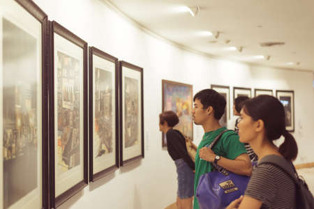 Bangkok, Thailand - June 16, 2019: young Thai people view artworks at an exhibition in Bangkok Art and Culture Center.のeditorial素材