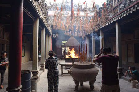 Ho Chi Minh City, Vietnam - April 27, 2019: visitors and worshipers in front of ritual fire in Thien Hau Pagoda. The pagoda is one of the highlights of Cho Lon, Saigon Chinatown.のeditorial素材