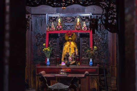 Ho Chi Minh City, Vietnam - April 27, 2019: one of the altars of Ha Chuong Hoi Quan pagoda with statue of Hanuman and wooden carving depicting army of monkeys. The temple located in Cho Lon, Chinatownのeditorial素材