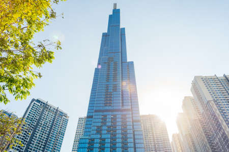 Ho Chi Minh City, Vietnam - February 19, 2019: Landmark 81 and other Vinhomes Central Park high-rise buildings, with the sun shining and lens flares. The tallest skyscraper in Vietnam & Southeast Asiaのeditorial素材