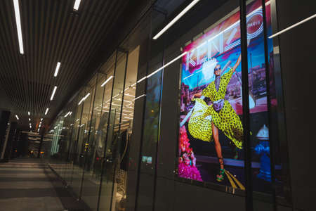 Ho Chi Minh City, Vietnam - April 23, 2019: a Kenzo shop exterior at a night colonnade of Saigon Centre Shopping Mall with a colorful promotional poster.のeditorial素材