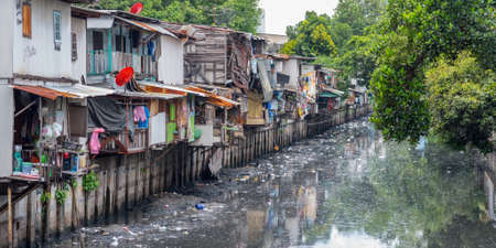 Bangkok, Thailand - September 25, 2018: slums along a smelly canal (Khlong Toei) full of mud and garbage in Khlong Toei District.のeditorial素材