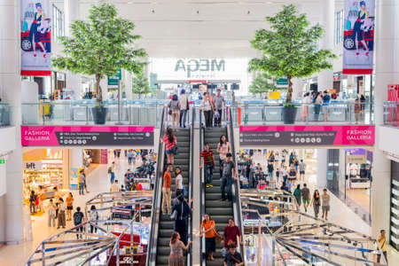 Bangkok, Thailand - July 27, 2018: an interior with two plastic trees and an escalator in Mega Bangna Shopping Mall.のeditorial素材