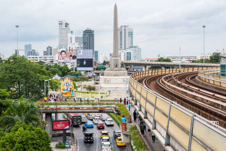 Bangkok, Thailand - August 12, 2018: Victory Monument with a park, street traffic and BTS rails. The obelisk is devoted to the Thai victory in the Franco-Thai War (1940â1941).のeditorial素材