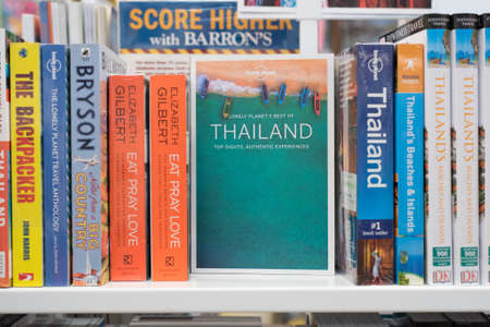 Bangkok, Thailand - October 4, 2018: travel books about Thailand and other countries (in English) on a shelf of the Asia Books shop in Mega Bangna Shopping Mall.のeditorial素材