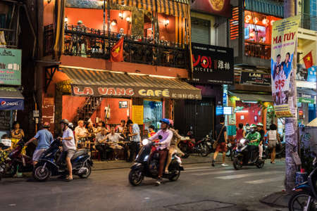 Ho Chi Minh, Vietnam - April 26, 2018: Bui Vien Street vibrant nightlife - La Vang Cafe with visitors and chaotic traffic.のeditorial素材
