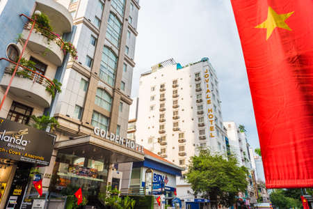 Ho Chi Minh City, Vietnam - April 29, 2018: 4-star Golden Central Hotel Saigon, Joviale Hotel and the flag of Vietnam in Ly Tu Trong Street, District 1.のeditorial素材