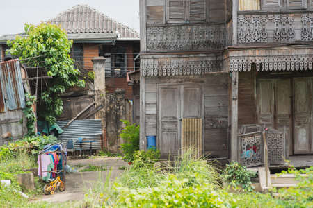 Bangkok, Thailand - June 24, 2018: Windsor House (on right), a historical teakwood of XIX century, and its yard located in Kudeejeen (Kudichin) area, next to the Chao Phraya River.のeditorial素材