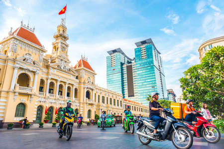 Ho Chi Minh City, Vietnam - April 30, 2018: Saigon City Hall, Vincom Center towers, colorful street traffic & tropical plants against the amazing blue sky. Saigon downtown with its famous landmarks.のeditorial素材