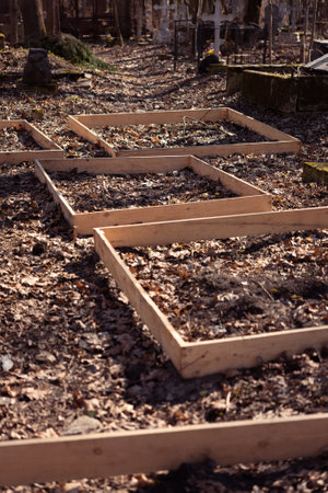 Plank frames defining sites for new graves at a Russian cemetery in St. Petersburg, Russia.の写真素材