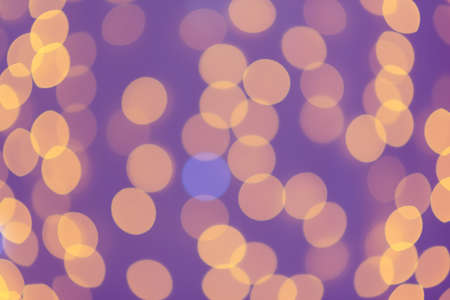 Blurred abstract: blurry orange circles in the purple background.の写真素材