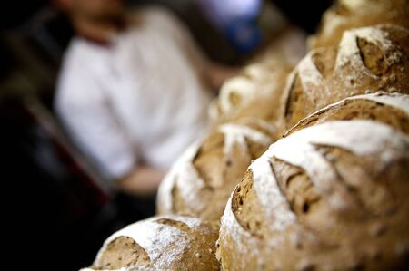 baker at work with warm, hot bread