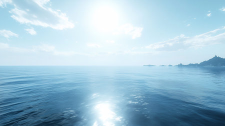 A tranquil ocean scene with sun reflecting on the water, creating a bright, shimmering effect. Distant islands and a mountainous coastline add depth to the serene blue landscape.の素材