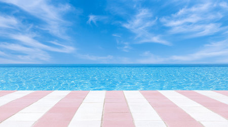 A tranquil scene featuring a pool with clear blue water, a vibrant sky with wispy clouds, and a striped pink and white tiled deck, evoking a sense of relaxation and summer bliss.の素材