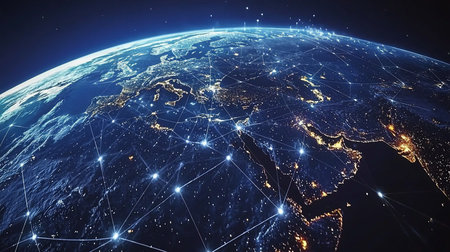 A digital rendering of Earth, showcasing continents with city lights, overlaid with a network of glowing lines. The globe is partially lit, with a dark space background.の素材