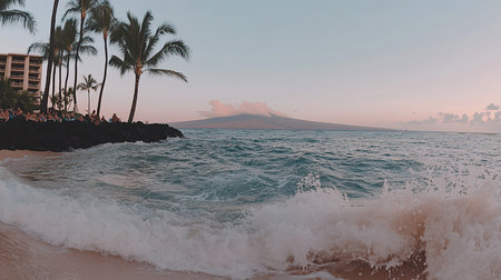The image showcases ocean waves crashing onto a sandy beach. The water is turquoise, and the scene is bathed in the warm hues of sunset.の素材