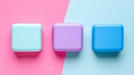 Three square blocks with rounded edges, in pastel shades of blue, purple, and cyan, are neatly arranged in a row.の素材