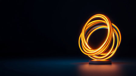 Dynamic abstract sculpture featuring multiple intertwined glowing orange and yellow neon rings, emitting vibrant light and resting on a sleek dark circular base.の素材