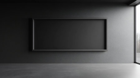 A solid black, rectangular frame is mounted on a dark, textured wall, creating a minimalist and modern aesthetic.の素材