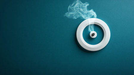 A white ring incense holder with a dark incense stick emitting smoke, set against a textured teal background.の素材