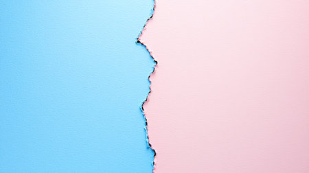 Two textured paper surfaces, light blue and pink, meet at a jagged, torn edge, creating a contrasting color division.の素材