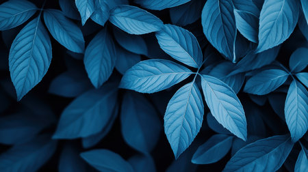 A detailed view of blue-toned leaves, showcasing their intricate vein patterns and textured surfaces, creating a visually appealing natural composition.の素材