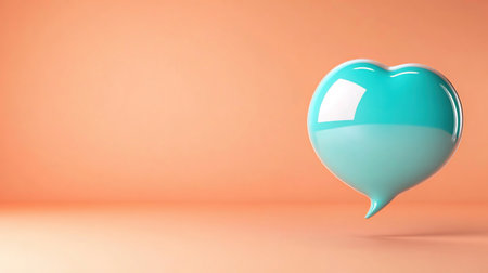 A turquoise heart-shaped speech bubble on a peach background, symbolizing love and communication.の素材