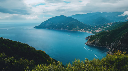 A breathtaking vista of a coastline featuring mountains, a vast sea, and vibrant green vegetation under a cloudy sky.の素材
