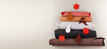 The Christmas tree is made of pieces of leather material. A Christmas tree made of leather workshop...